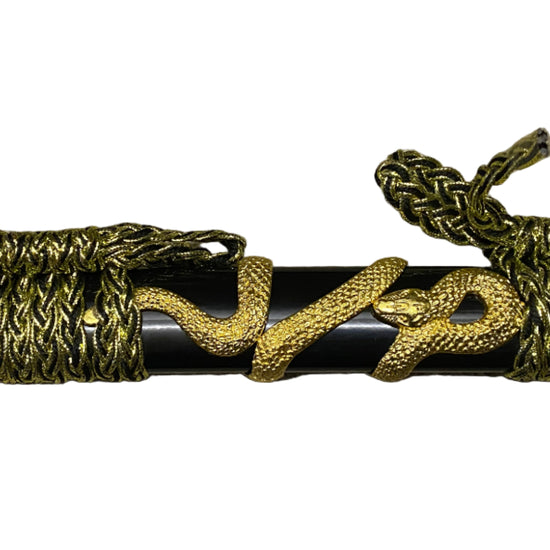 Decorative sword with gold and black design on a white background