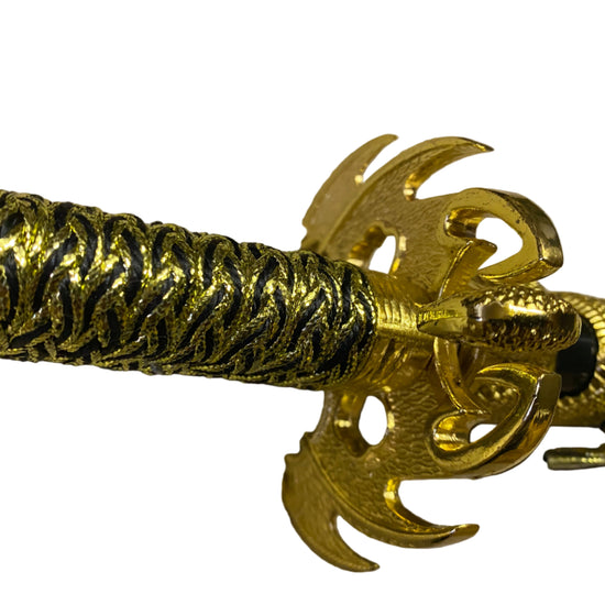Gold bracelet with intricate design on a beige background