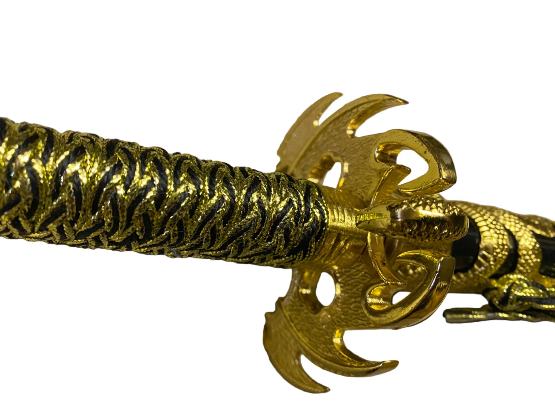 Gold bracelet with intricate design on a beige background