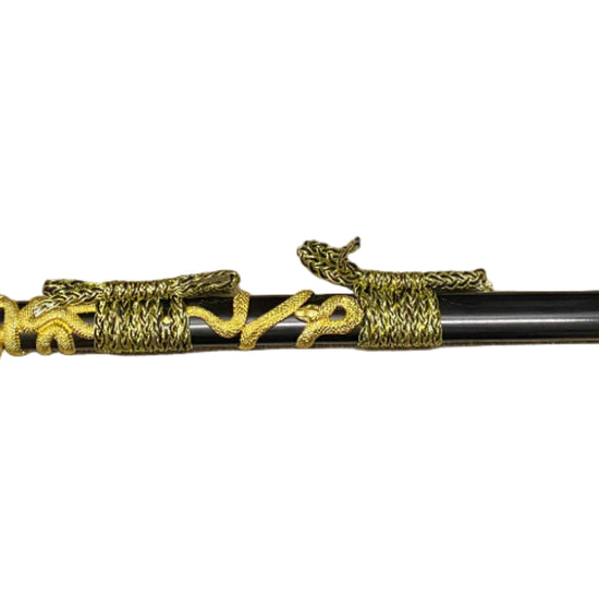 Decorative sword with gold and black design on a white background