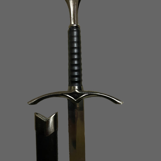 Sword with a black handle and silver blade on a gray background