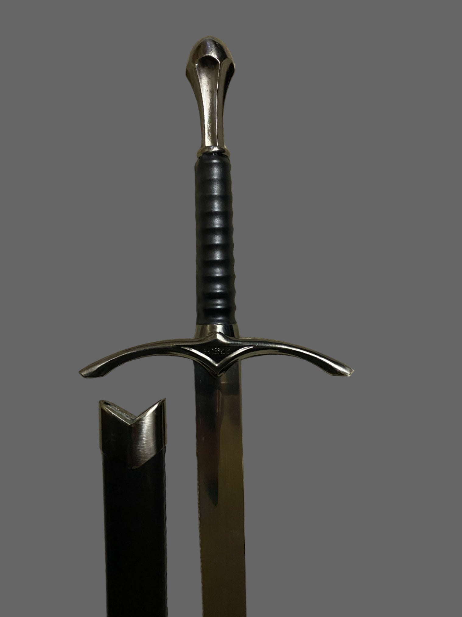 Sword with a black handle and silver blade on a gray background