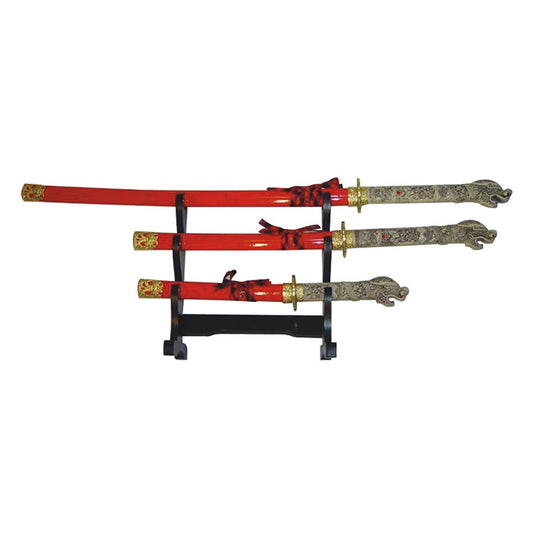Set of three red swords with decorative sheaths on a black stand against a white background