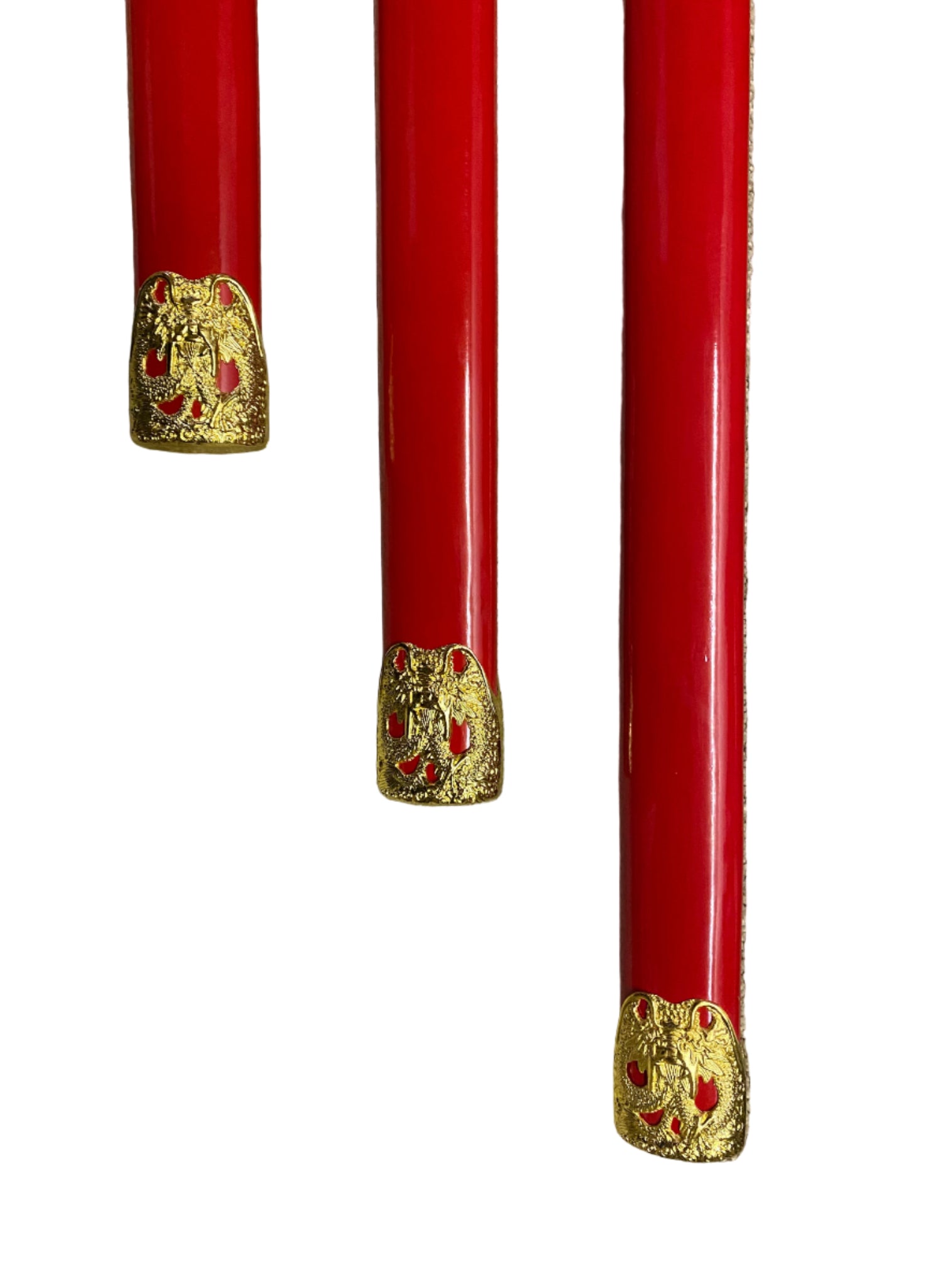 Three red objects with gold decorative elements on a white background
