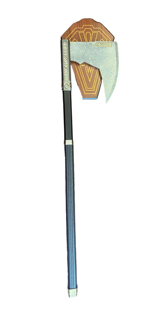 Decorative axe with a geometric head on a textured surface