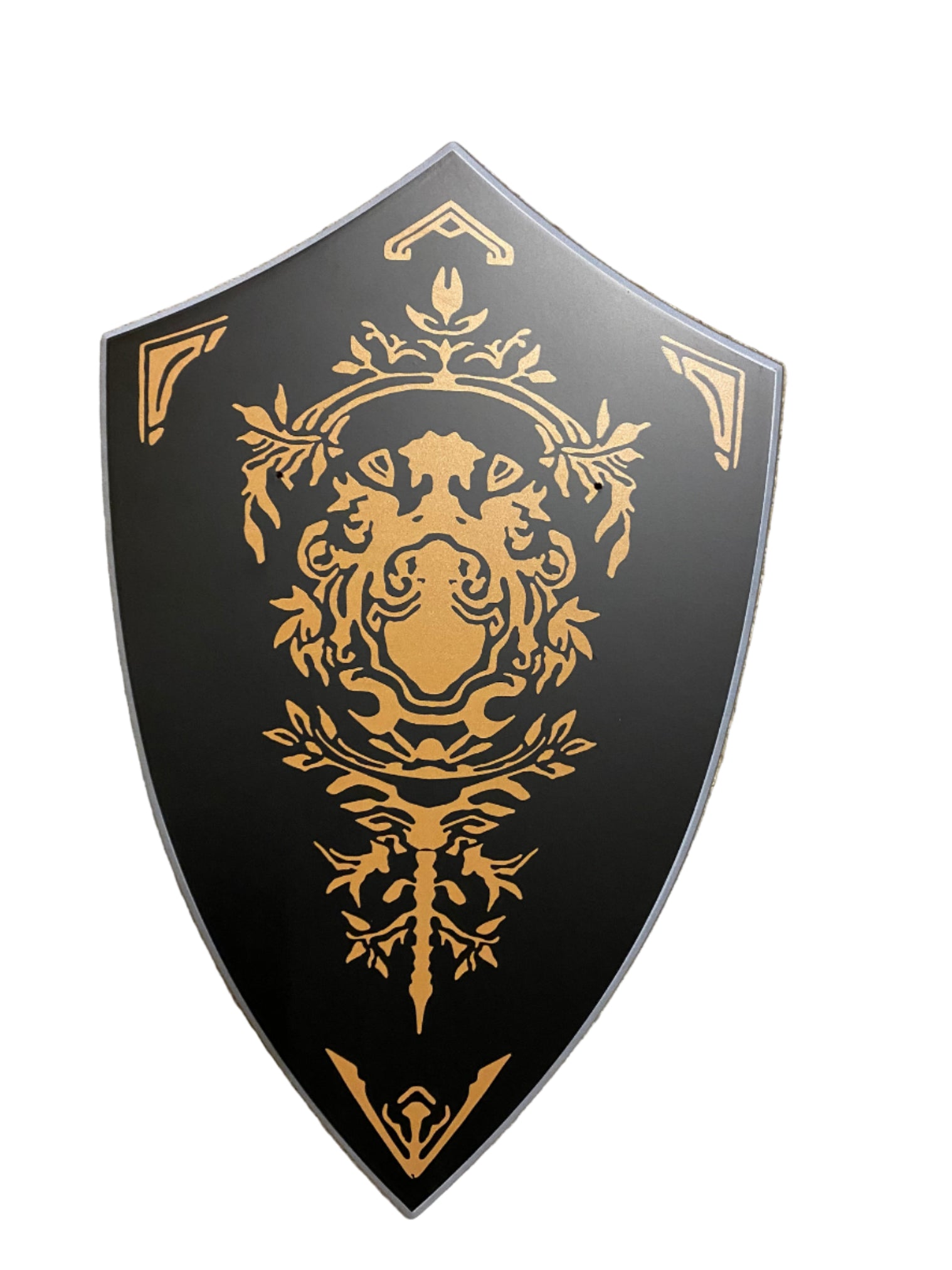 Decorative shield with gold emblem on a black background