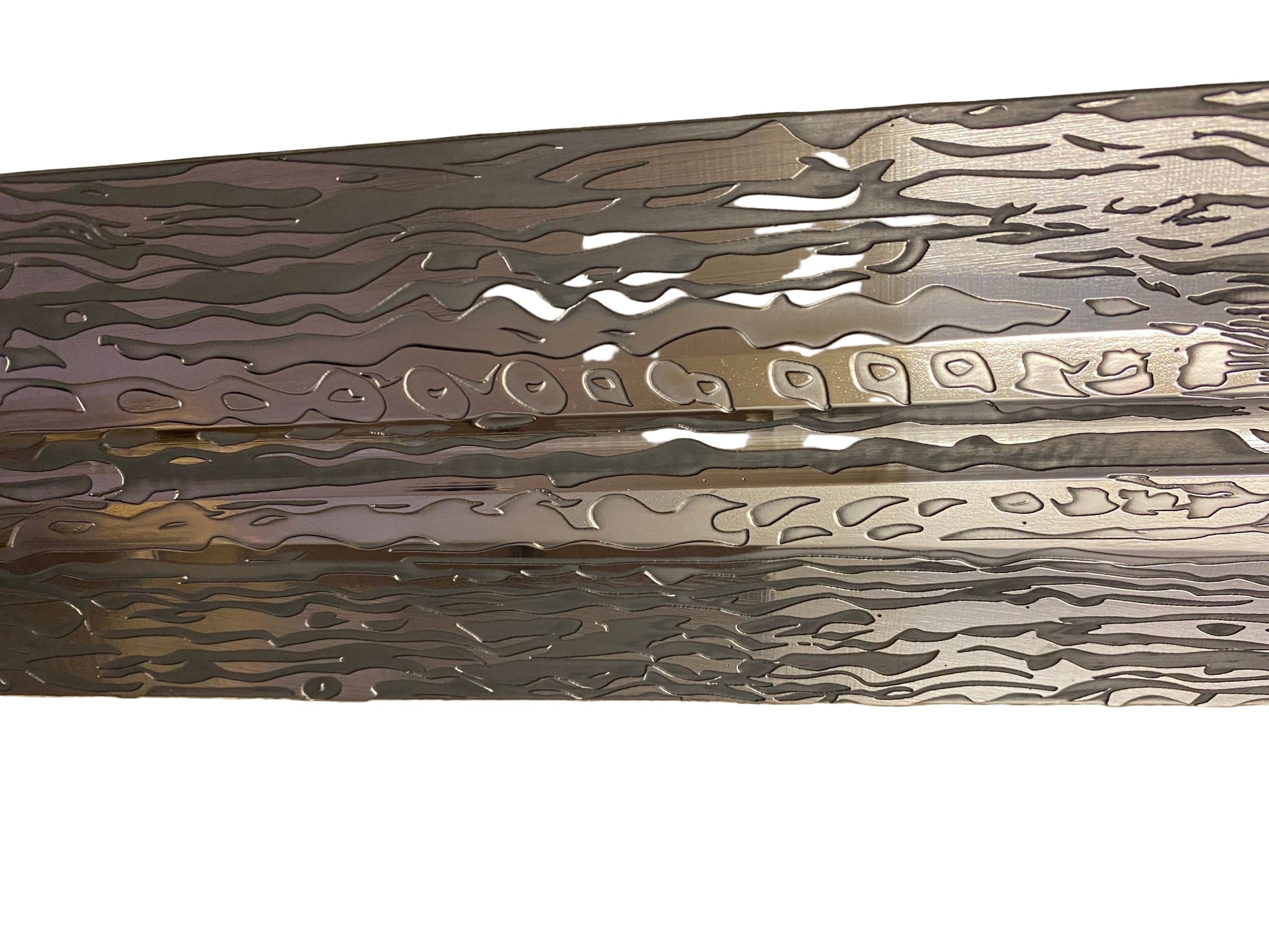 Metallic object with intricate patterns on a textured surface