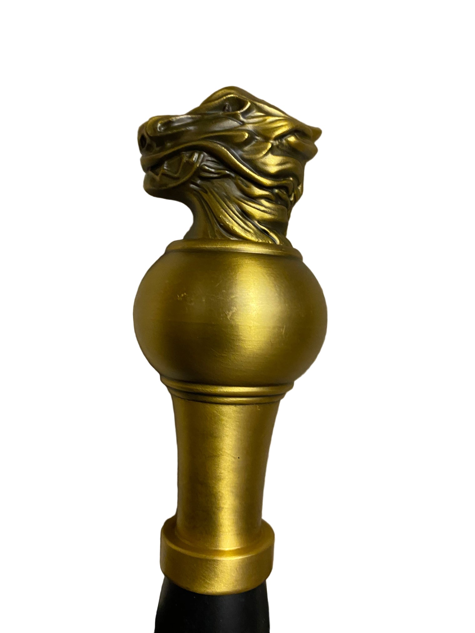 Decorative gold finial on a textured surface