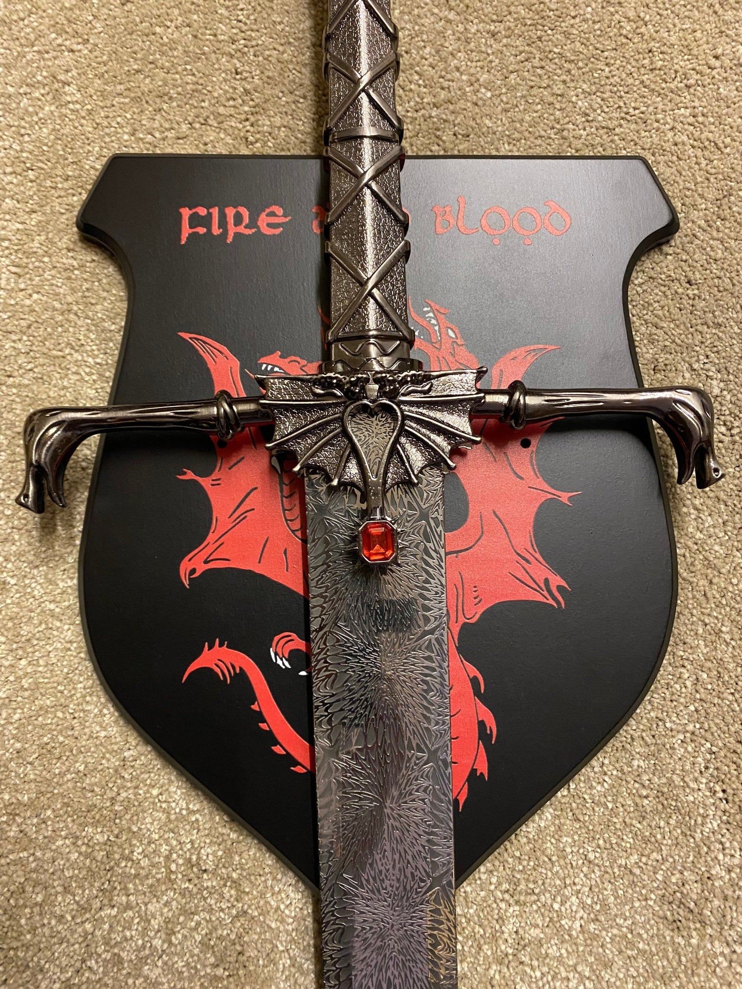 Decorative axe with dragon design and 'Fire' text on a beige background