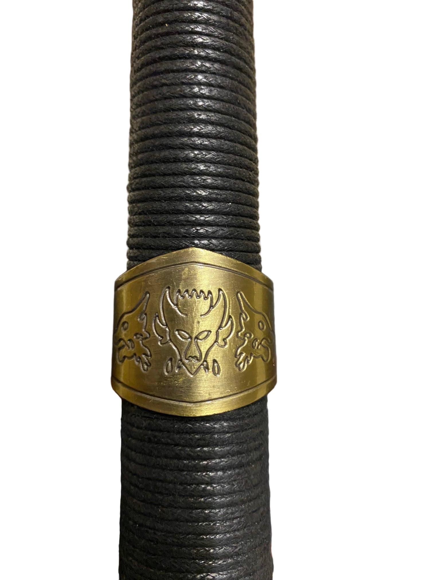 Black rope handle with a gold emblem on a textured surface