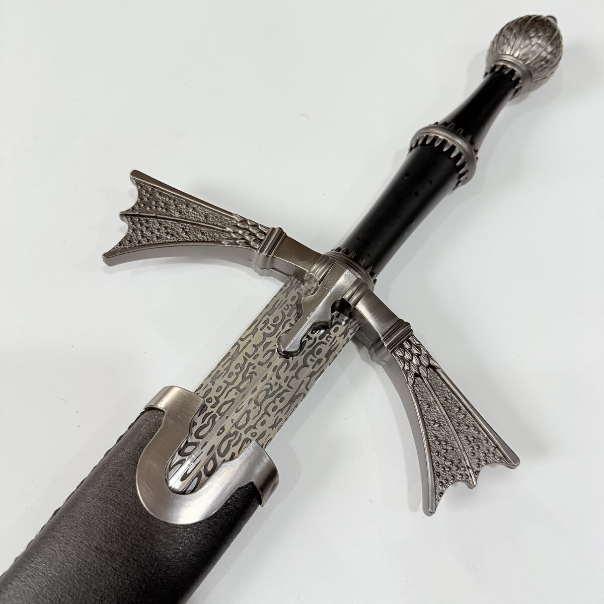 Decorative sword with intricate metalwork on a white background