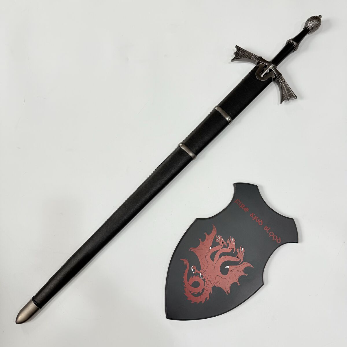 Sword and shield with dragon design on a white background