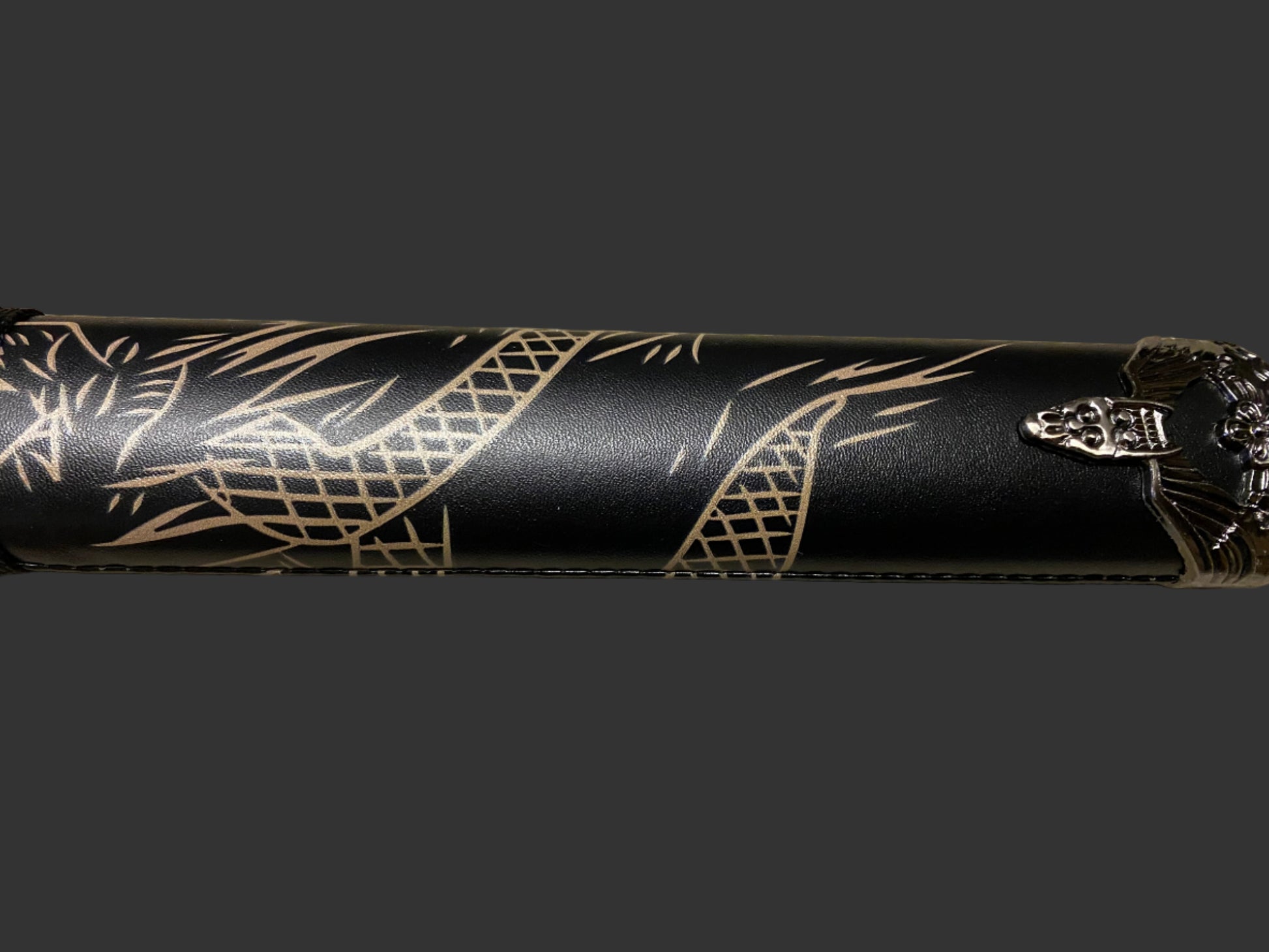 Black sword with gold patterns on a dark background