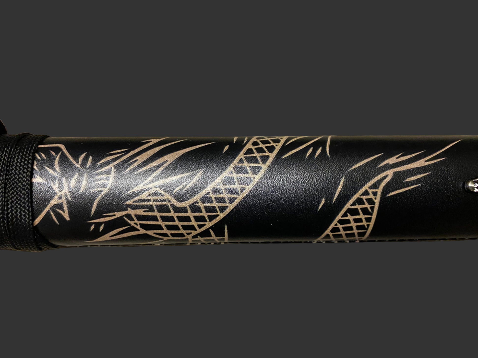 Black sword with gold tribal design on a black background