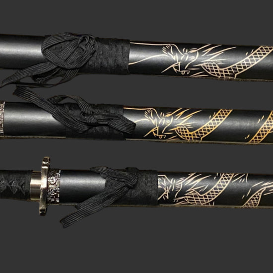 Three black and gold decorative swords on a dark background