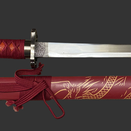 Sword with red sheath featuring dragon design on a black background
