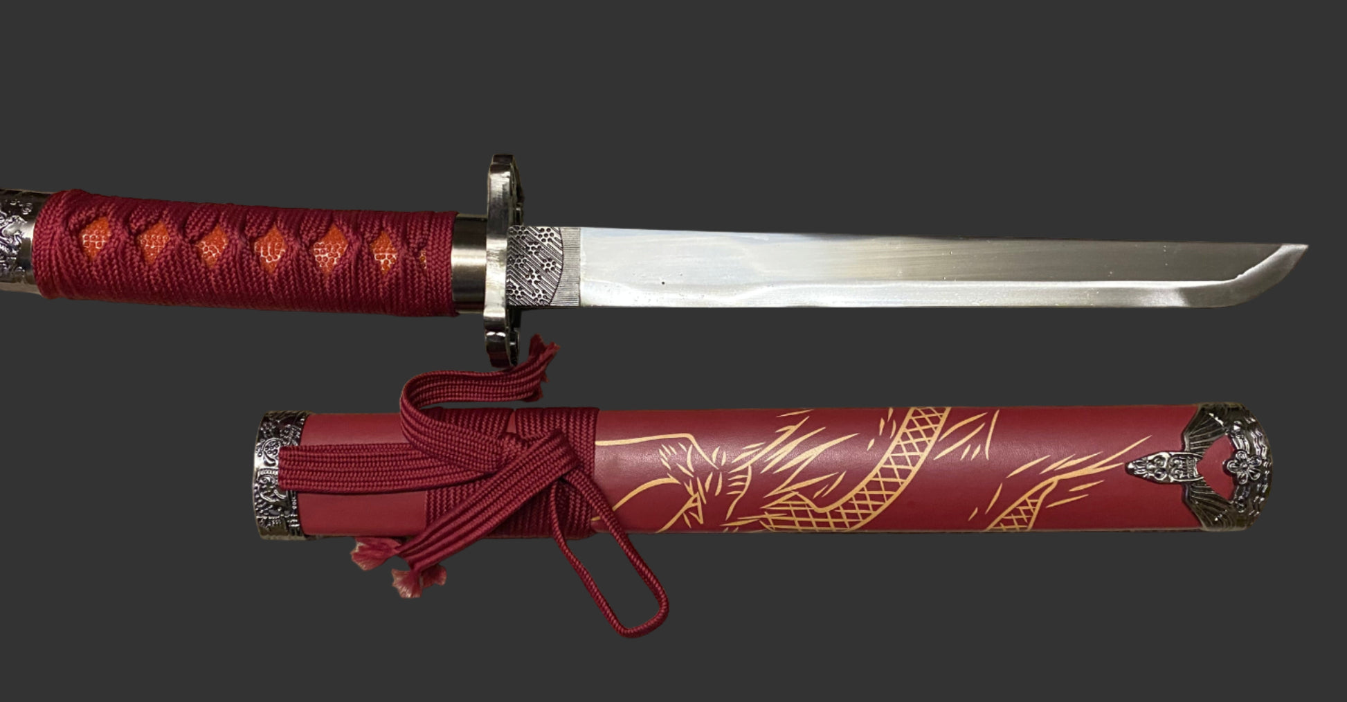 Sword with red sheath featuring dragon design on a black background