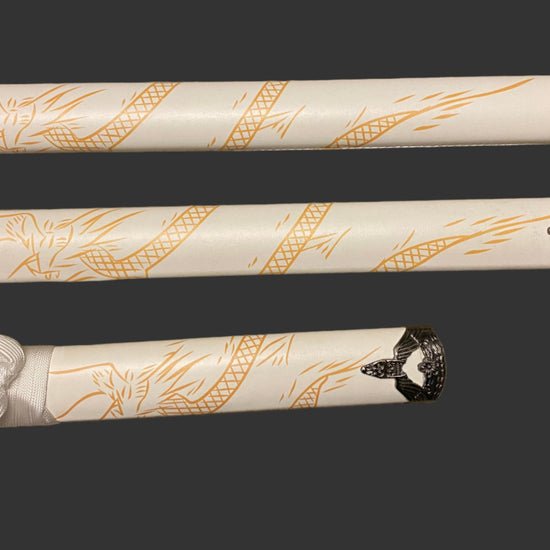 Three decorative sword sheaths with intricate gold patterns on a dark background