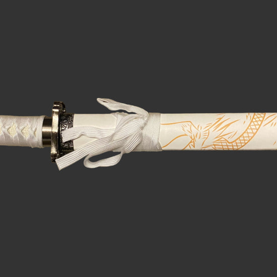 Decorative sword with white handle and gold patterns on a black background