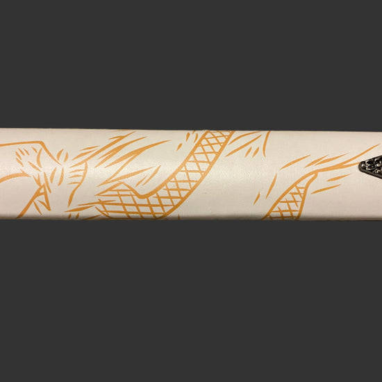 Close-up of a white sword with gold designs on a black background