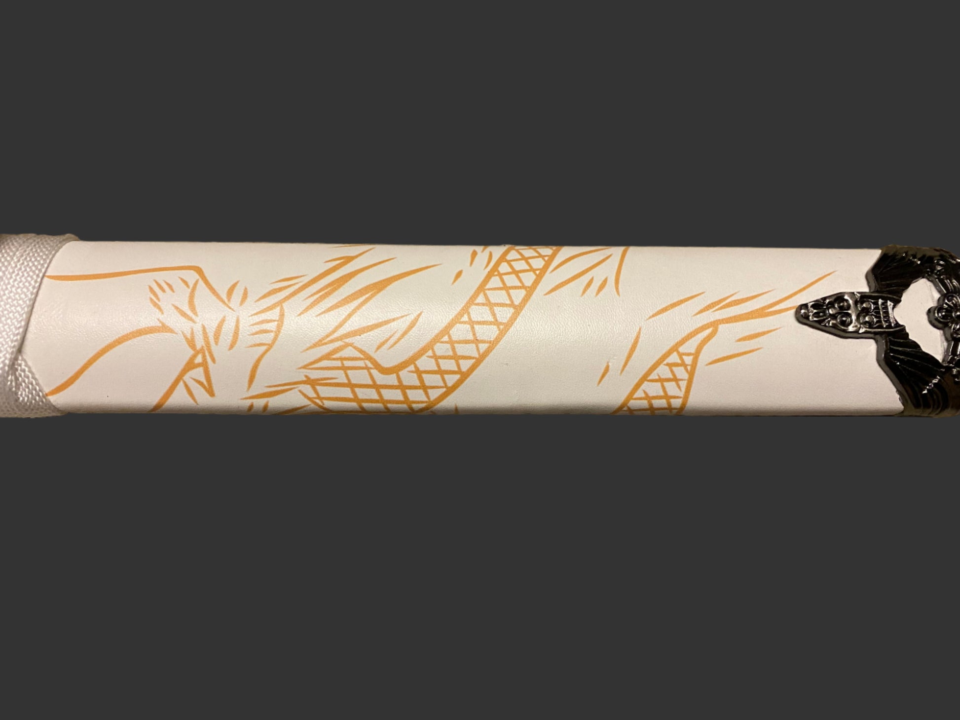 Close-up of a white sword with gold designs on a black background