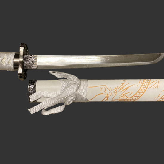Decorative sword with white sheath featuring dragon designs on a black background