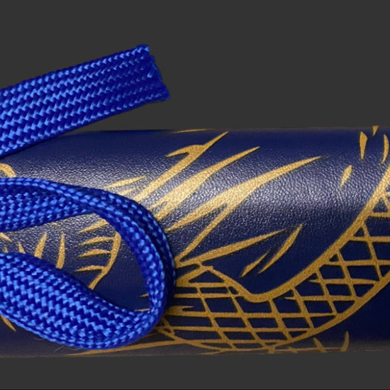 Blue sword with gold patterns on a dark background