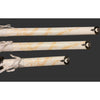 Three decorative sword sheaths with intricate gold patterns on a dark background