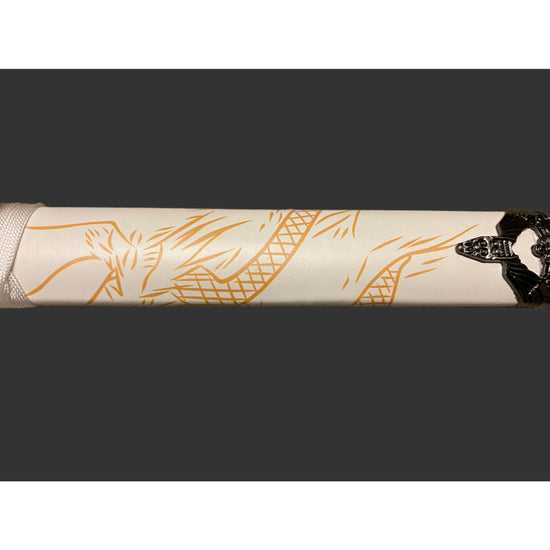 Close-up of a white sword with gold designs on a black background