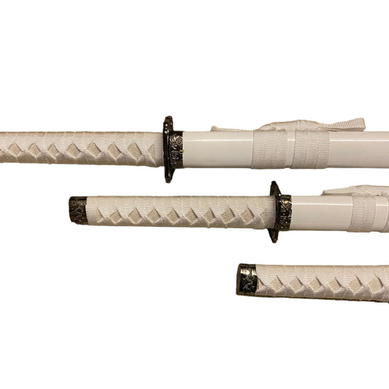 Three white swords with black handles on a white background