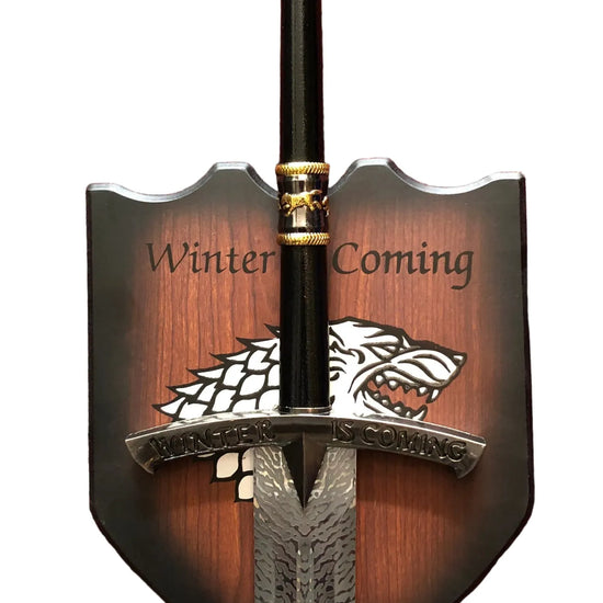 Decorative sword with 'Winter is Coming' and a wolf emblem on a white background