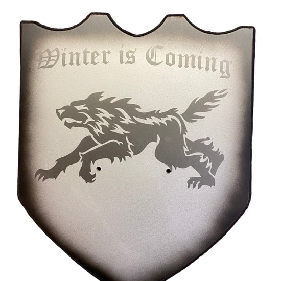 Shield with a lion emblem and 'Winter is Coming' text on a white background