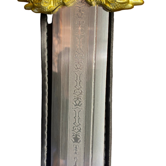 Decorative sword with gold winged hilt on a white background