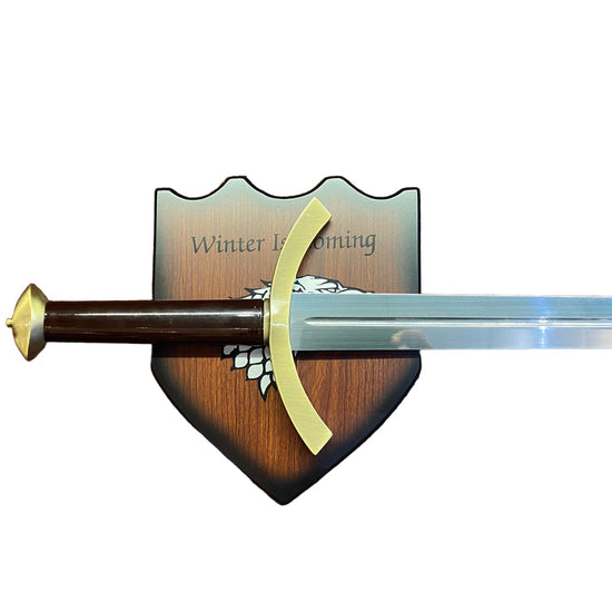 Sword with a wooden handle and gold accents on a white background