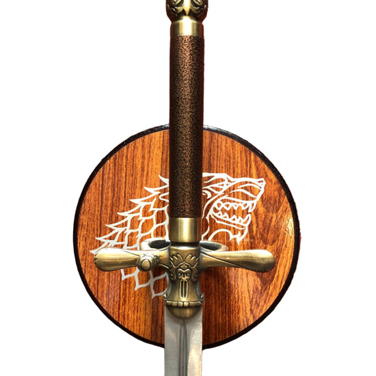Decorative sword with wooden sheath featuring a dragon emblem on a white background