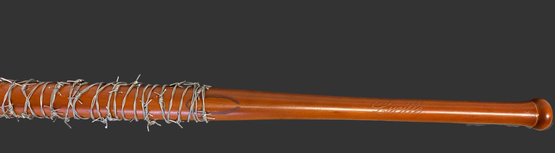 Wooden baseball bat with metal wrap on a black background