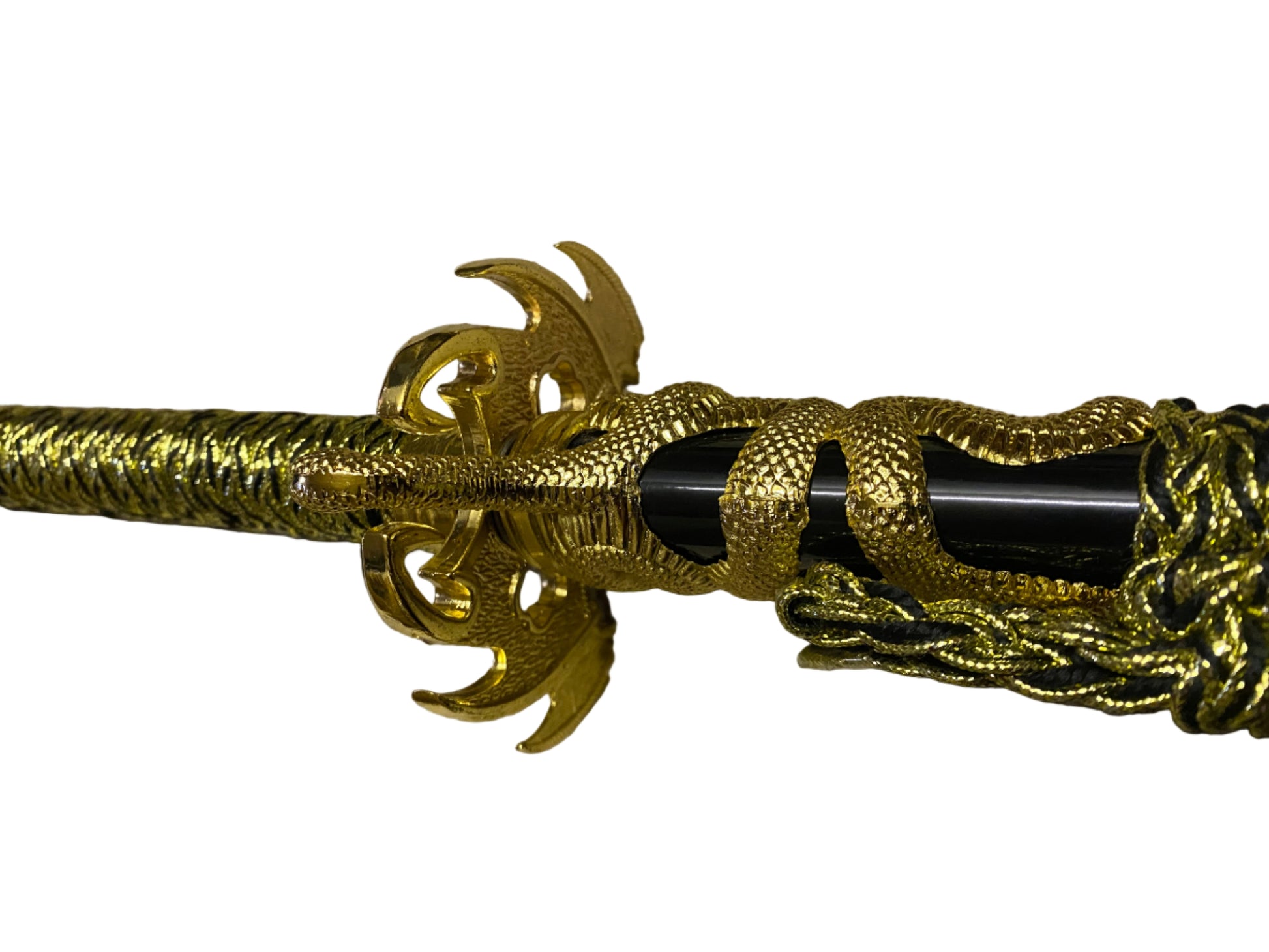 Decorative gold and black object with intricate design on a white background