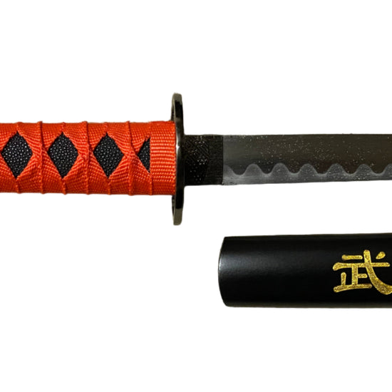Sword with red handle and black blade on a gray surface