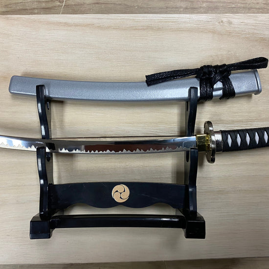 Sword on a stand with a wooden background