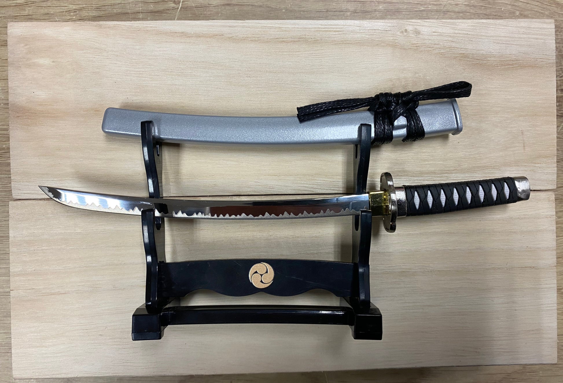 Sword on a stand with a wooden background