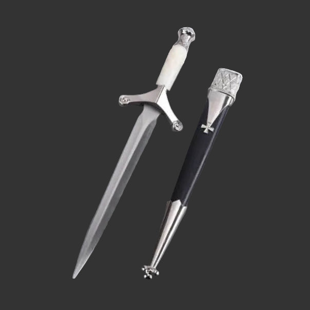 Decorative sword pen on a gray surface with a magazine underneath