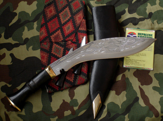 Decorative knife with black handle and silver blade on a camouflage background