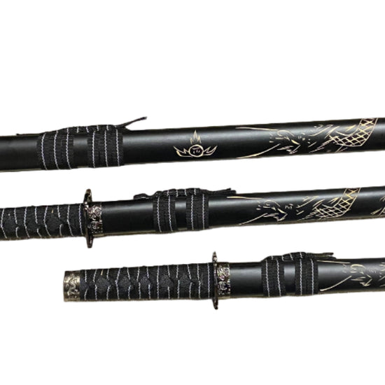 Set of black martial arts weapons with decorative patterns on a white background