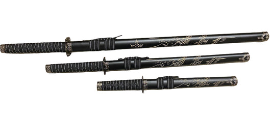Set of black martial arts weapons with decorative patterns on a white background