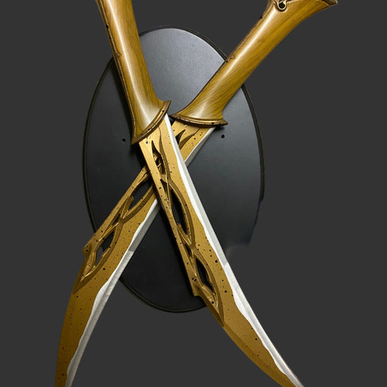 Decorative swords with gold and black design on a dark background
