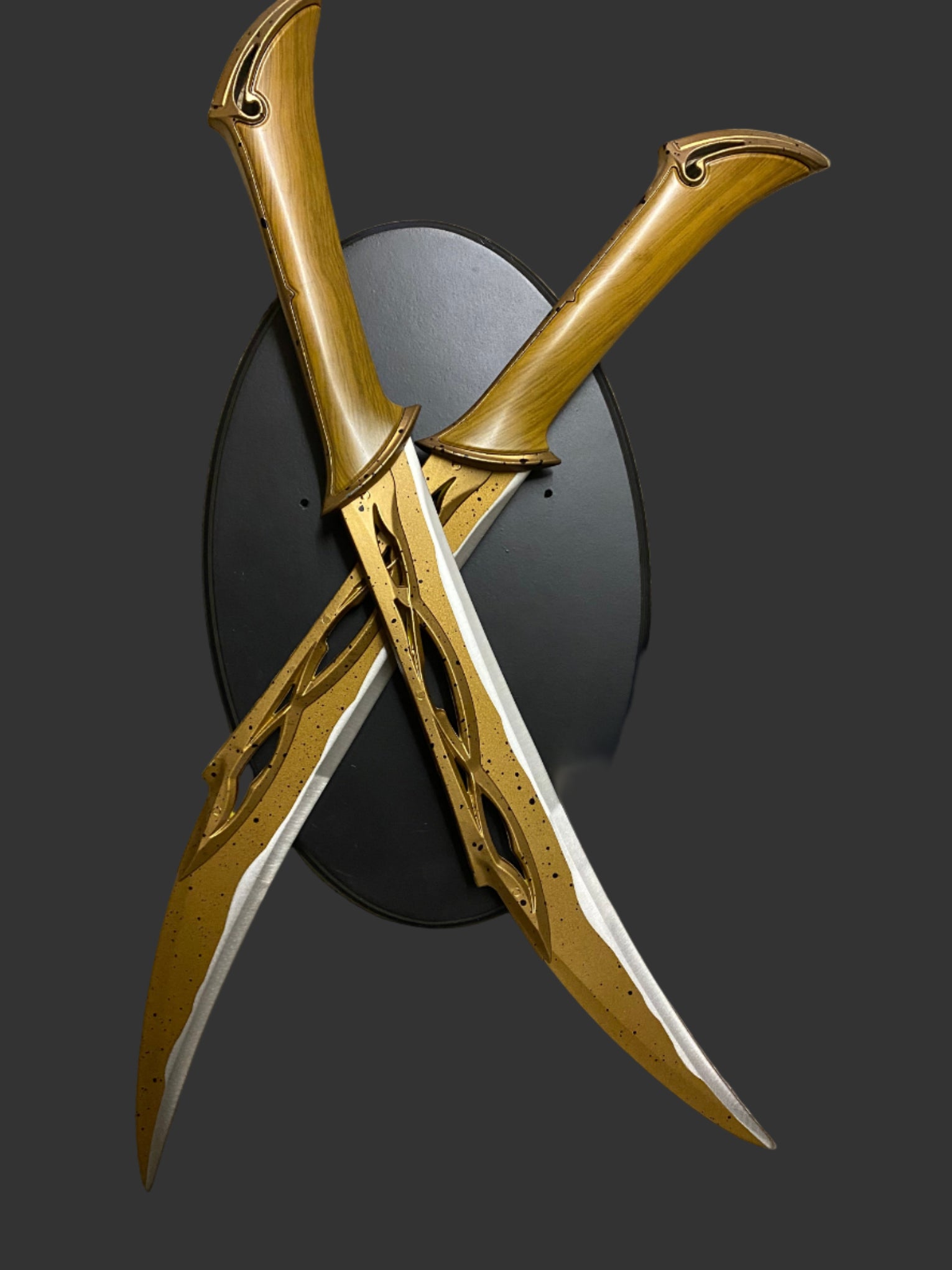Decorative swords with gold and black design on a dark background