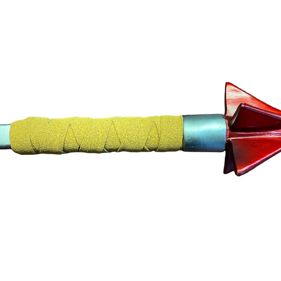 Close-up of a dart with a yellow grip and red and blue tip on a white background