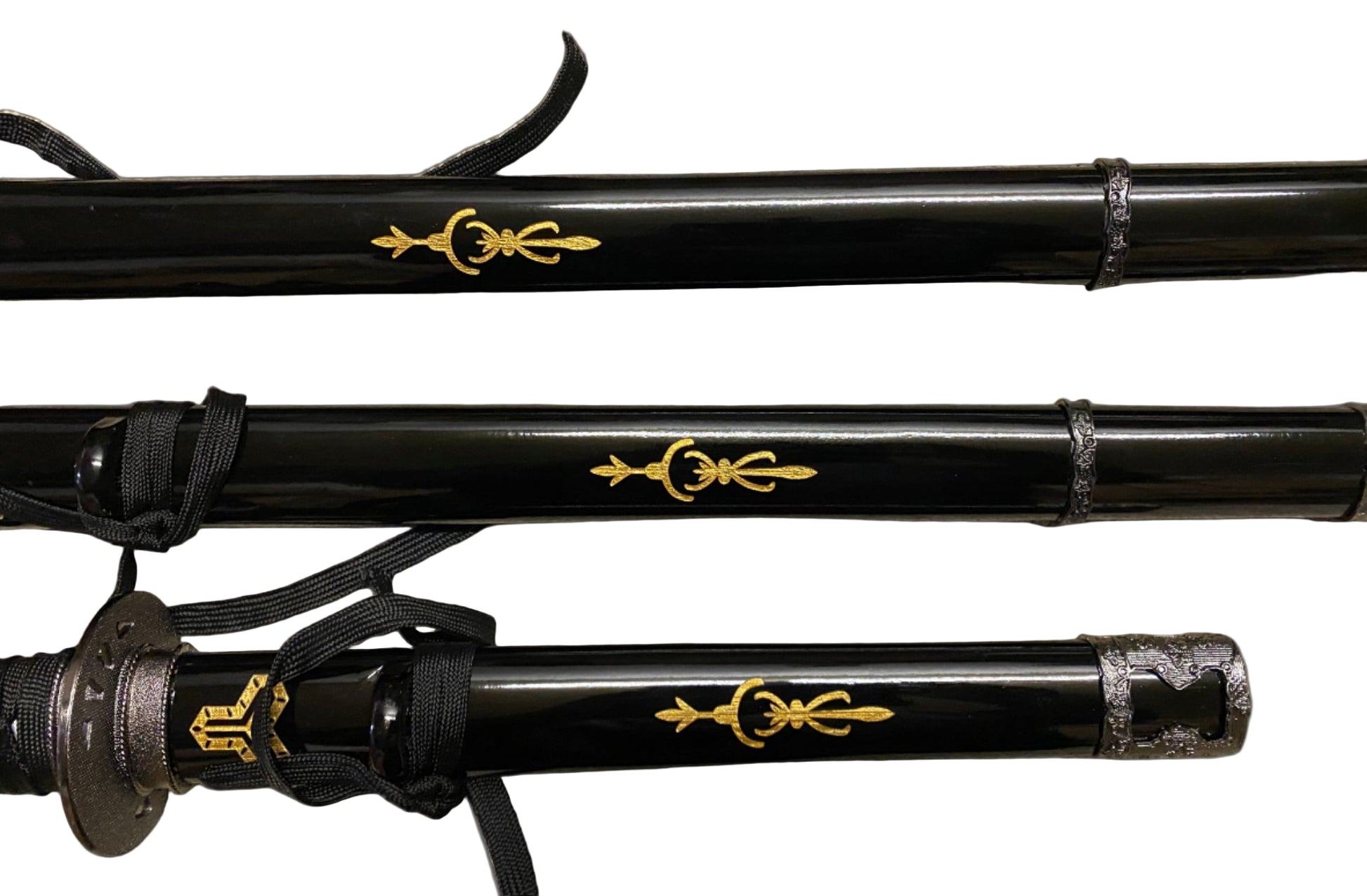 Three black sword handles with gold decorative symbols on a gray background