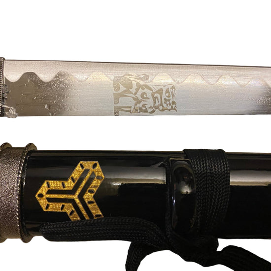 Sword with engraved blade and sheath on a grey background