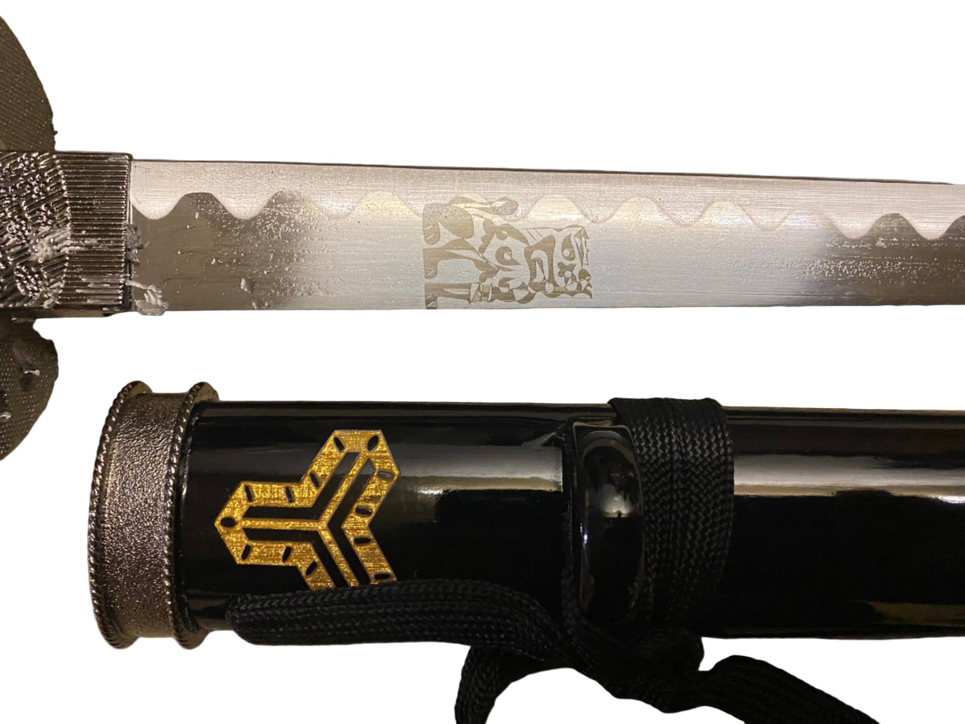 Sword with engraved blade and sheath on a grey background